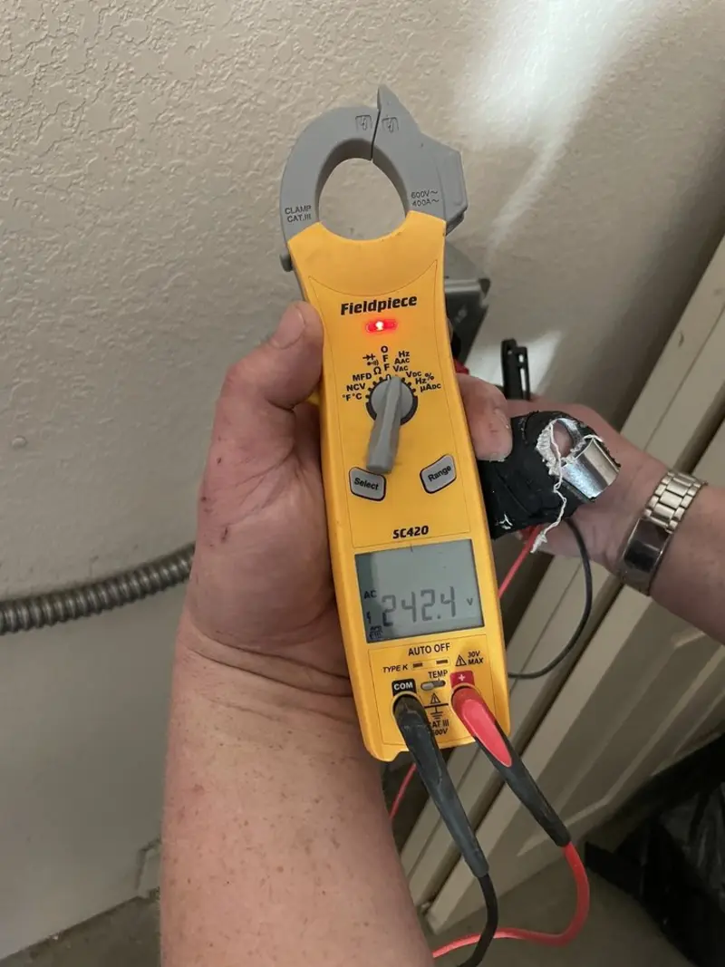 Voltage testing with clamp meter during Recessed Lighting Installation in Lilburn